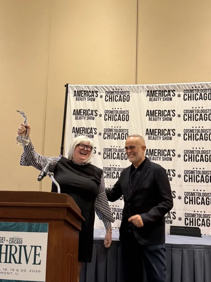 Kristen Erickson accepts her award from Luis Alvarez.
