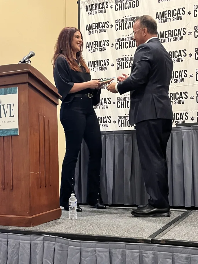 Kelsey Miller is presented her award by Frank Fulco, CEO, America's Beauty Show.