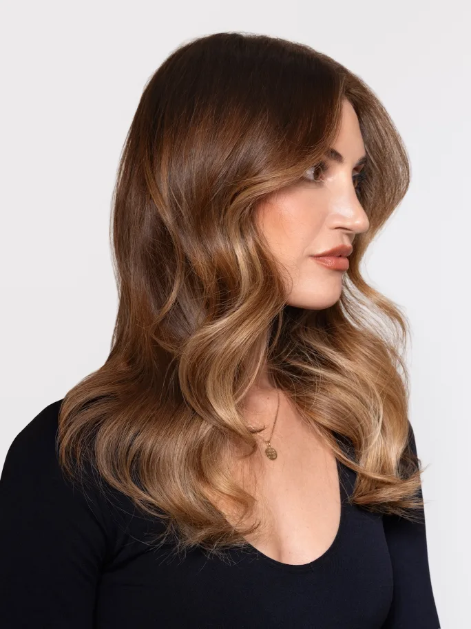 A brunette model wearing a scoop necked black tshirt