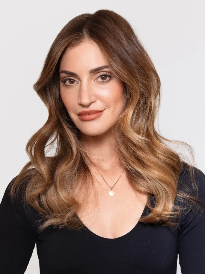 A brunette model wearing a scoop necked black tshirt