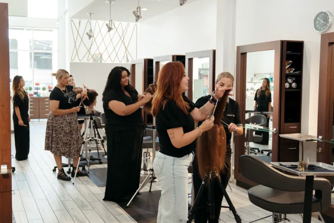 Stylists work on mannequins during a class at Karen Allen Salon.