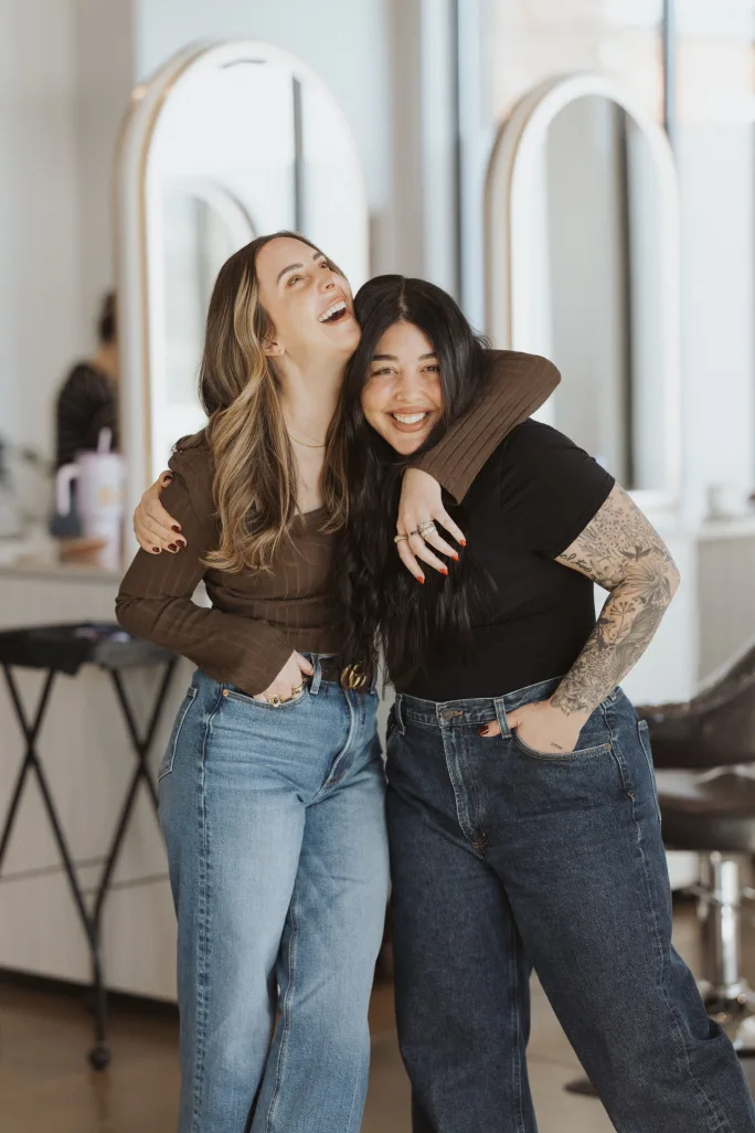 Two partners hugging in a salon