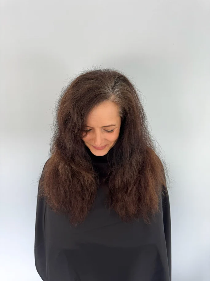 A woman with frizzy hair.