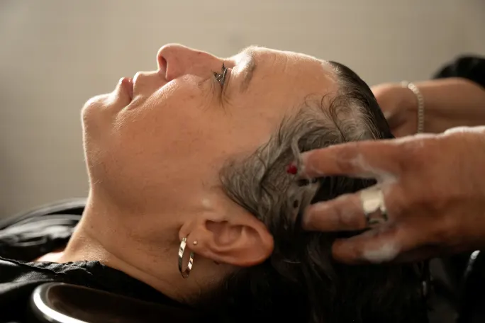 A woman having her hair shampooed