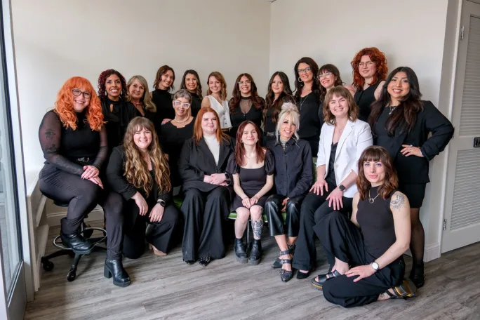 Dressed in black, the team from Legato Salon & Spa gather in the salon.