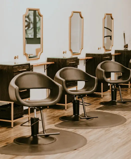 Gorgeous salon chairs welcome guests to their appointment at Lewis + Ivey Salon.