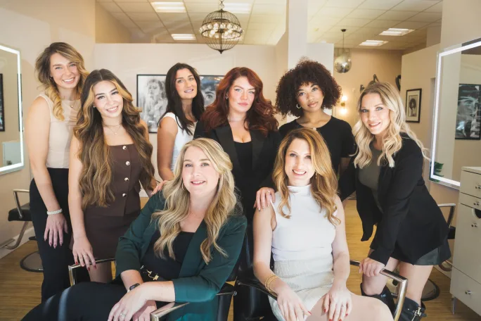 Posing in their salon, a team of stylists from Lola Hair Studio.
