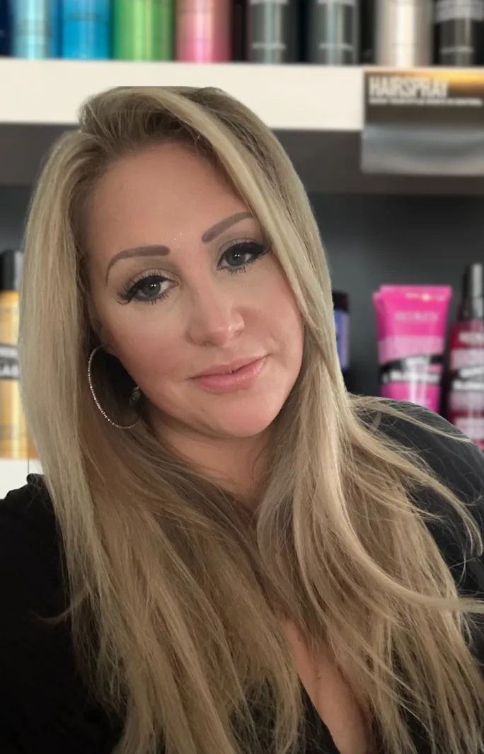 Tilting her long blond hair to the side, Kyndell Walker, salon manager at Genesis Salon and Spa