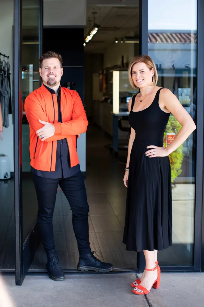 Chris Knudsen and Jenny Knudsen open the door of Mane Attraction Salon in welcome.