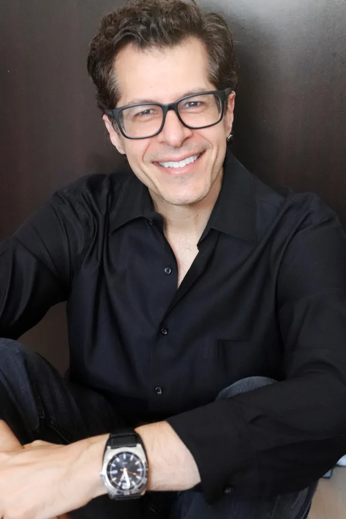A smiling man with glasses