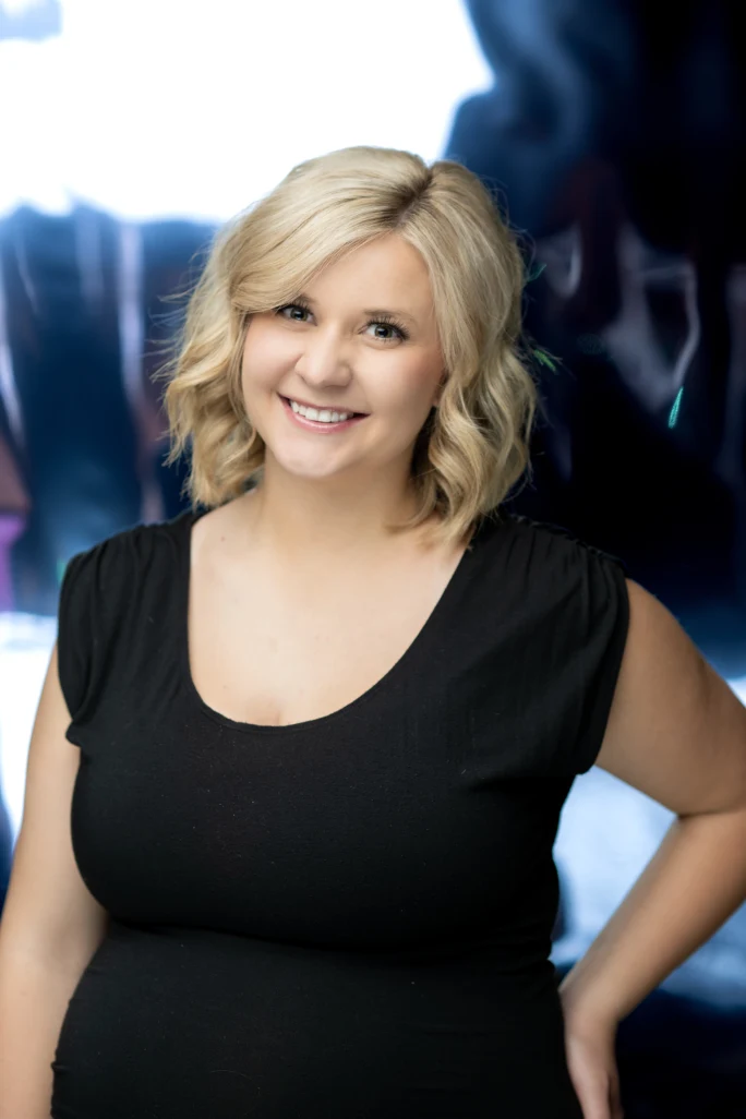 A smiling woman with blonde hair