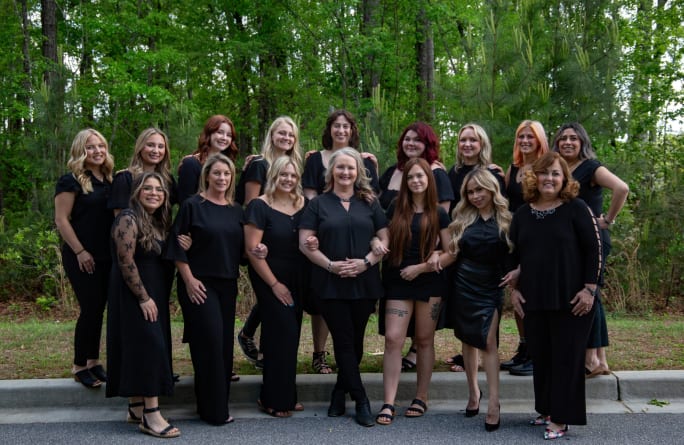Owner Crystal Mercer with her team stand outside in Summerville, South Carolina.