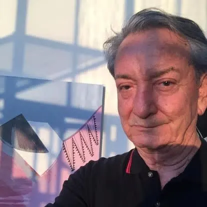 An older man standing in shadow