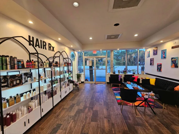 To the left are many retail shelves full of hair products while the reception area is to the right.