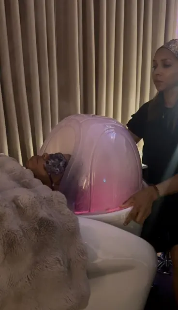A hairdresser sitting behind a headspa shampoo bowl