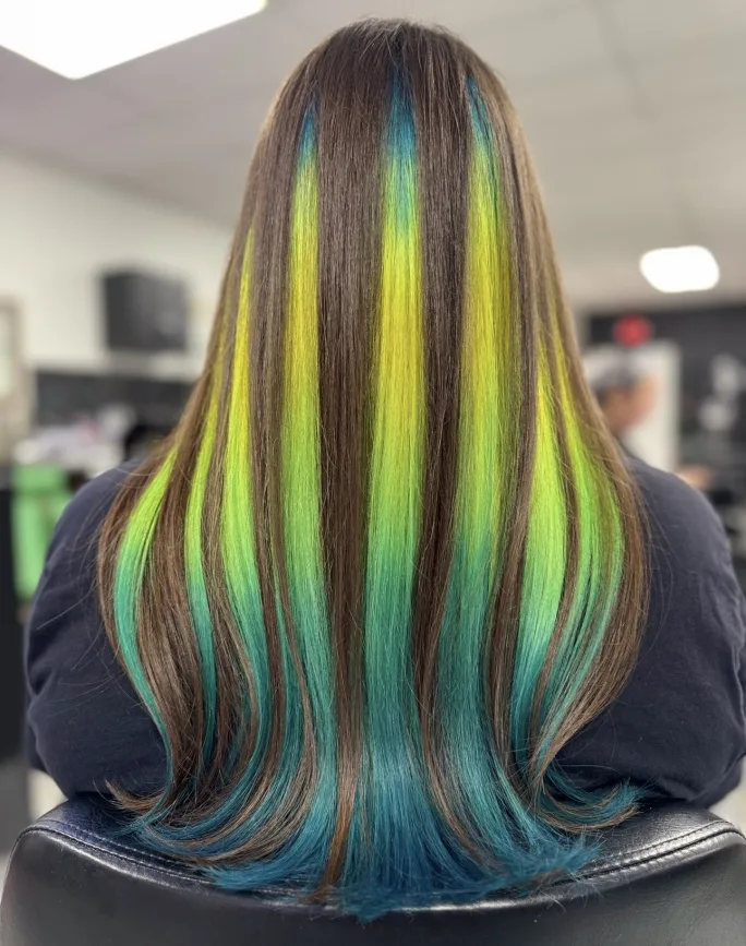 A green and brown striped hair color finish seen from the back.