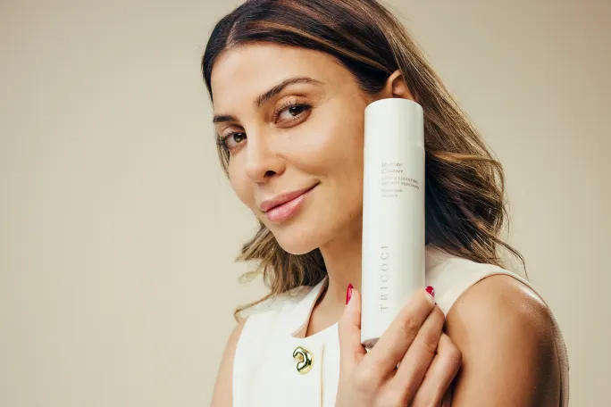 A model poses with Tricoci's Skin Hydrating Cleanser
