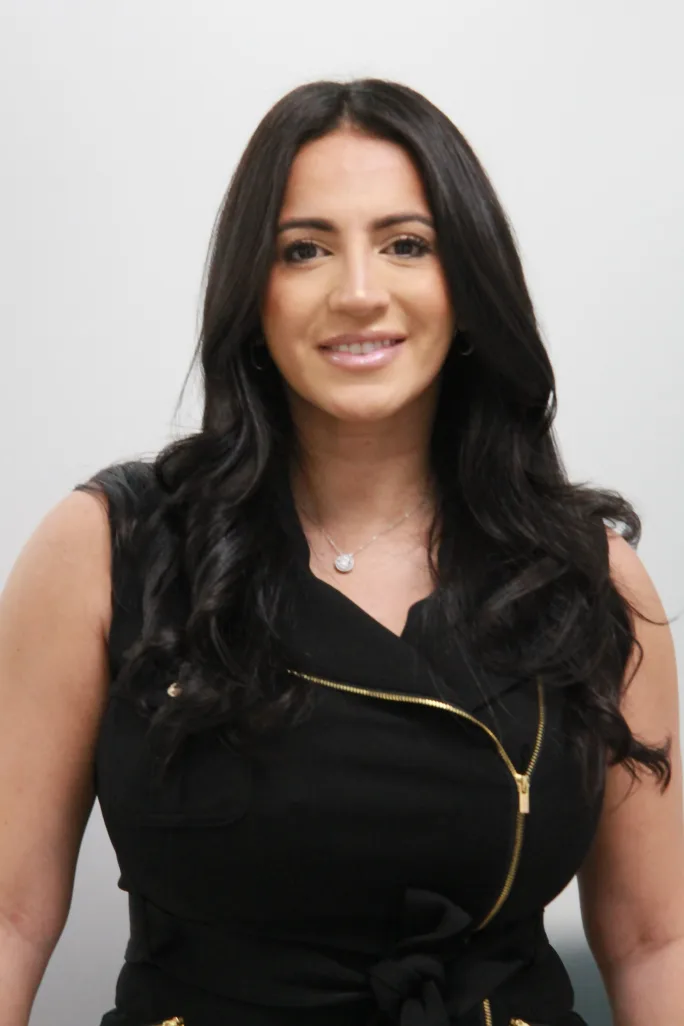 A woman with long brunette hair.