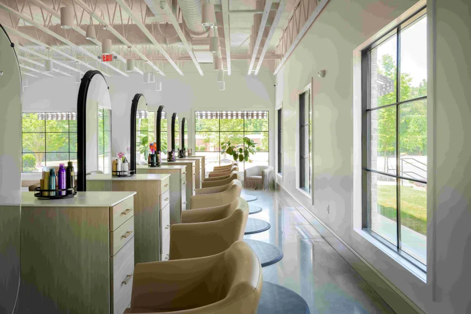 A row of chairs and stations at Mane 18