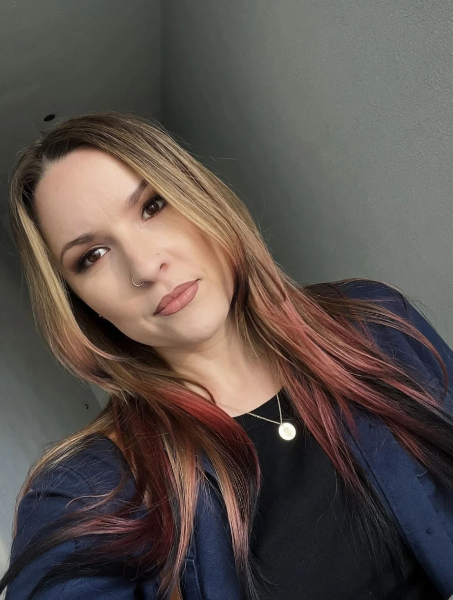 A young woman with hair that has panels of red and yellow.