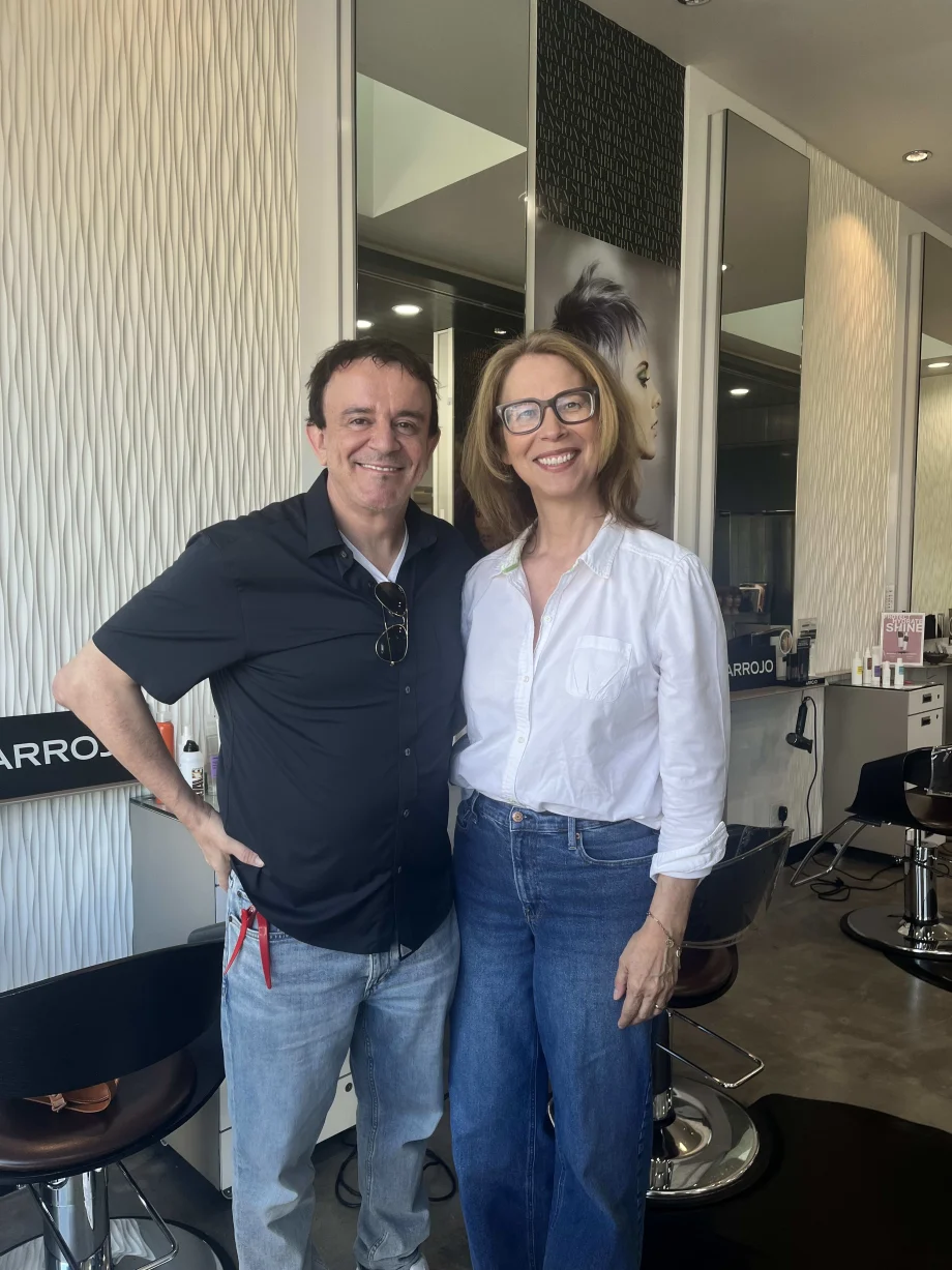 A man and a woman standing inside a salon