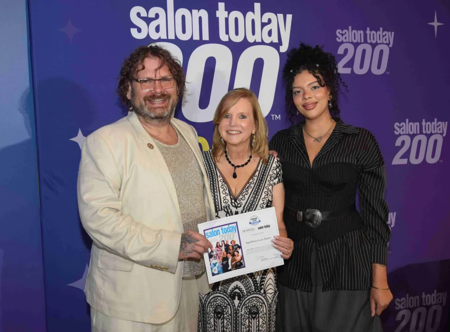 The team from Apotheca Lux Salon accept their award.
