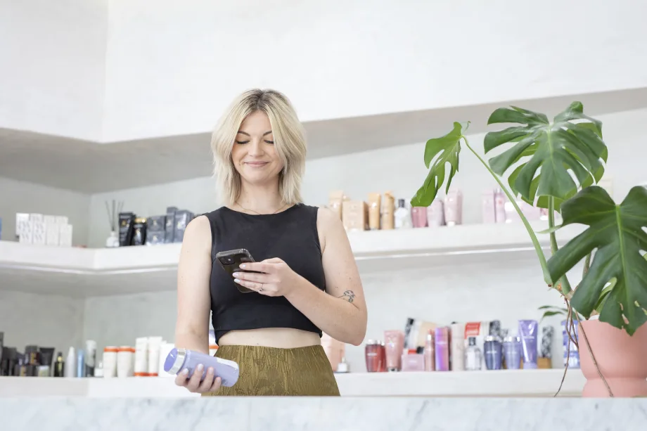 woman in salon scanning product with her phone