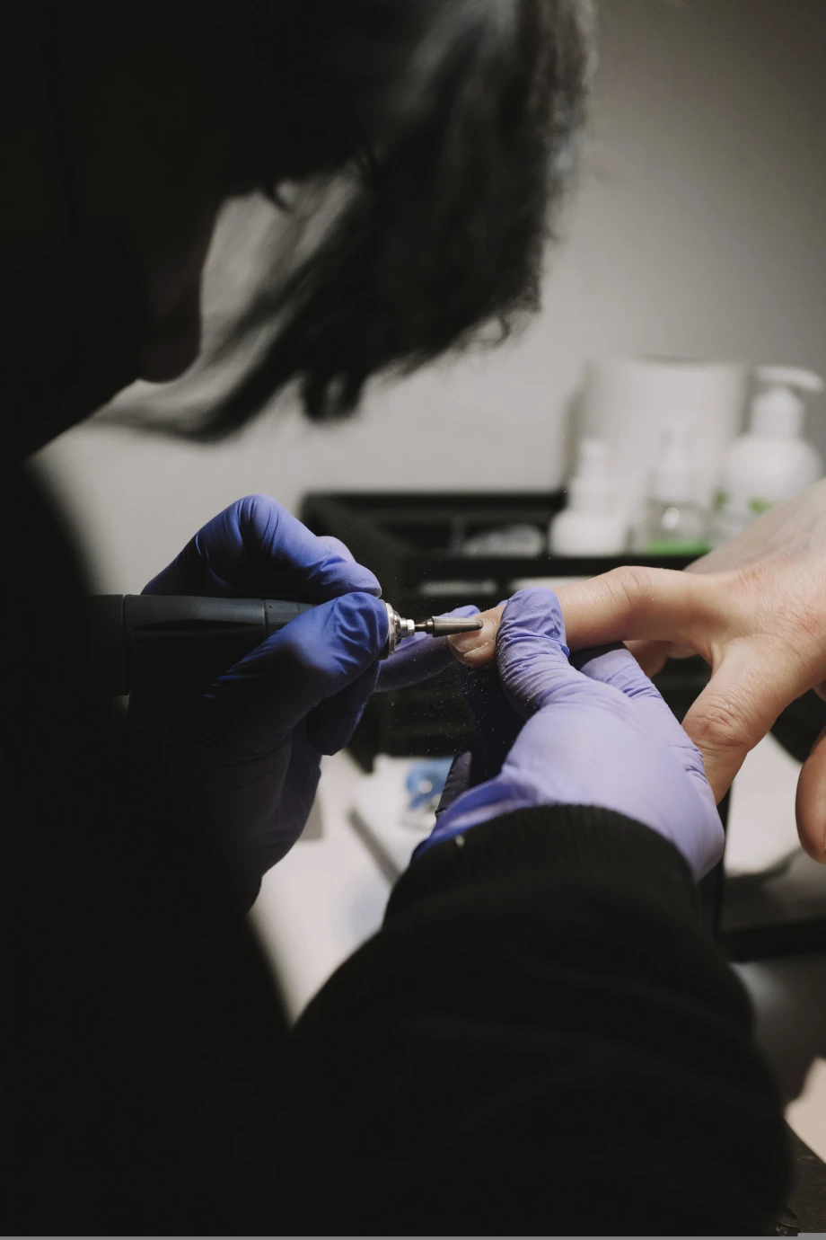 A nail tech doing a client's nails