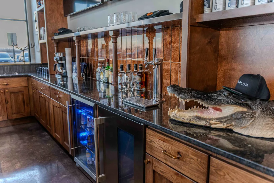 A smiling alligator head behind the bar is part of the nostalgic and fun decor at Parlor by Thompson & Company.