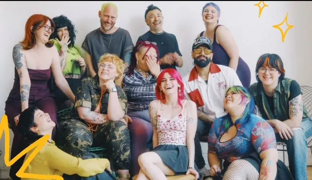The colorful team from Chicago's Bang! Salon share a laugh while posing.