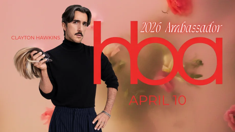 A man in a black turtleneck, holding hair extensions.
