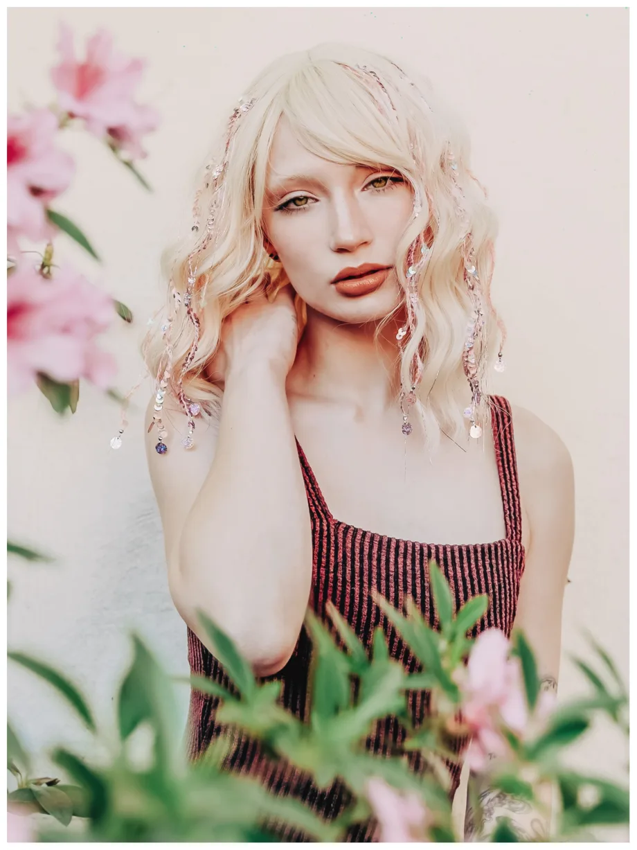 A blonde haired woman with tinsel strands.