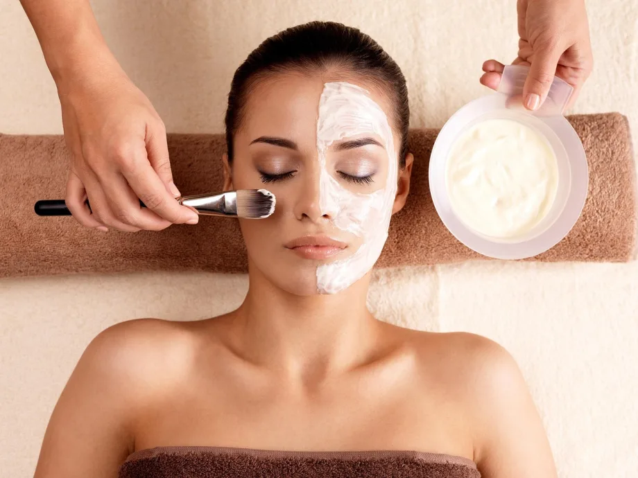 A woman receives a facial treatment.