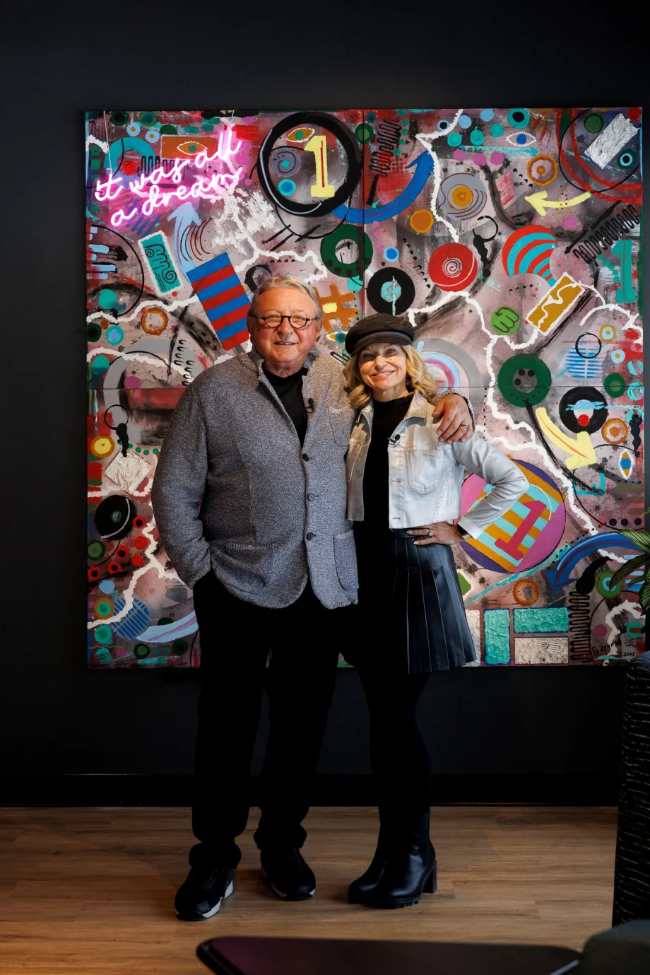 Charles and Debra Penzone in front of his original artwork.