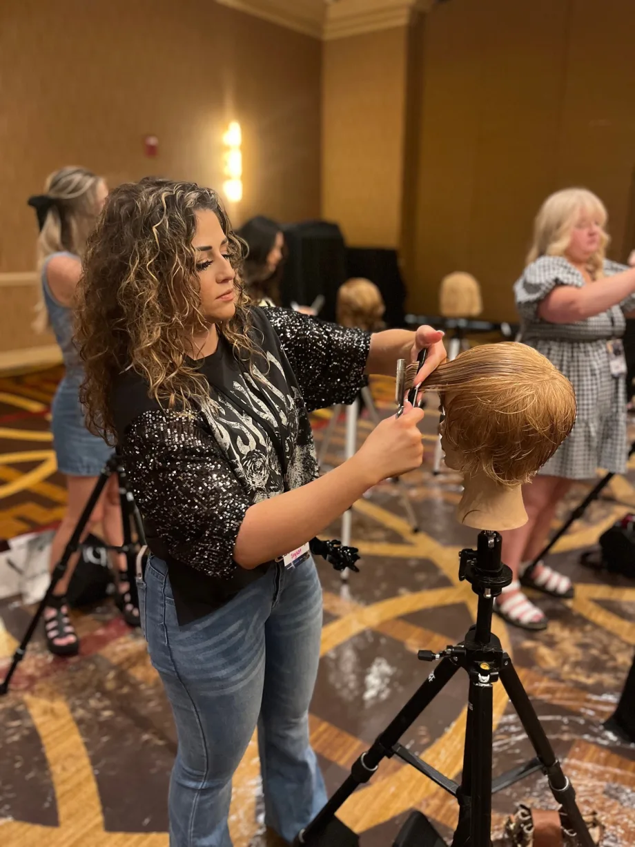 A hairstylist working on a mannequin