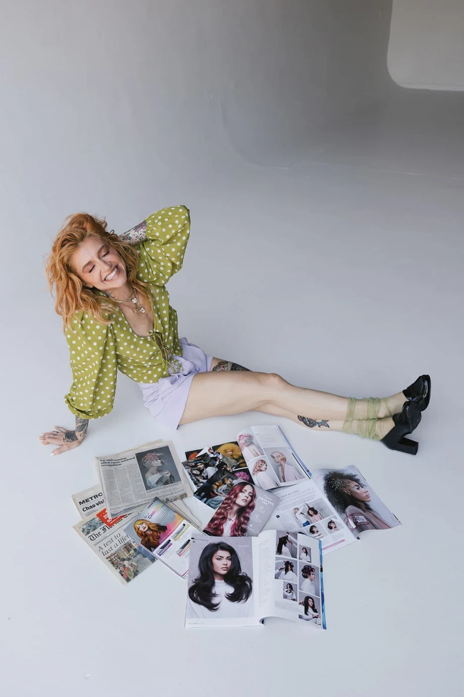 A woman surrouneded by magazines