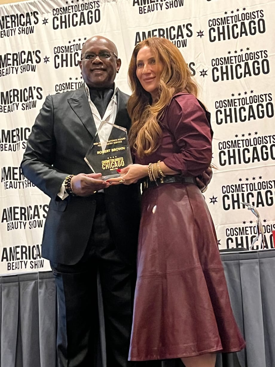 Robert Brown is presented his award by Anna Manukyan, Treasurer, Cosmetologist Chicago Board Member