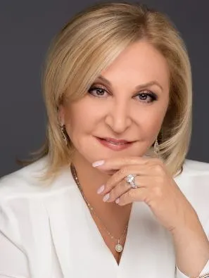 A woman holding her hand to her face.