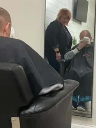 A hairstylist and her client, sitting in a chair