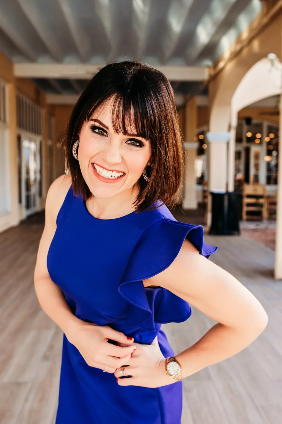 A smiling woman in a blue dress