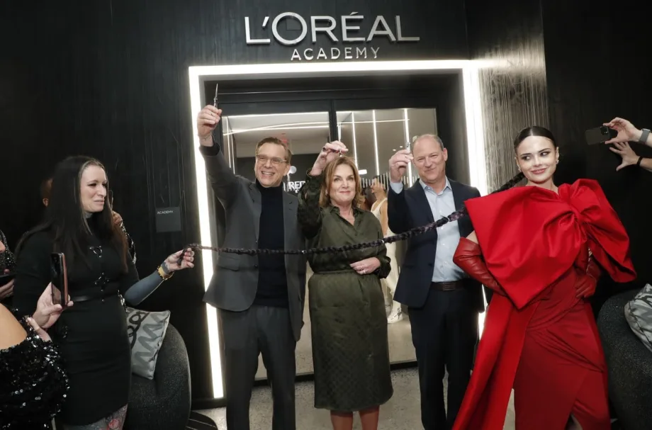 A ribbon cutting in front of the L'Oreal Academy.