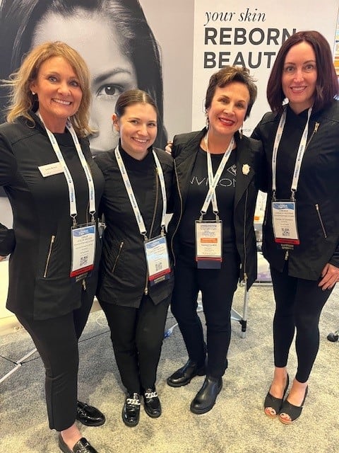 Four women at a trade show booth