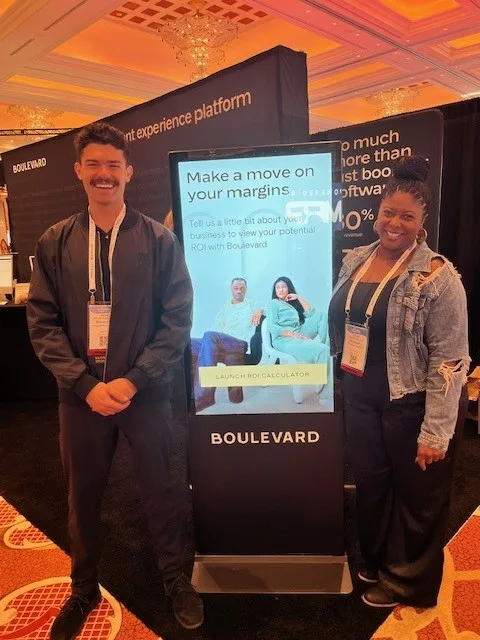 Two people, a man and a woman, at a trade show booth