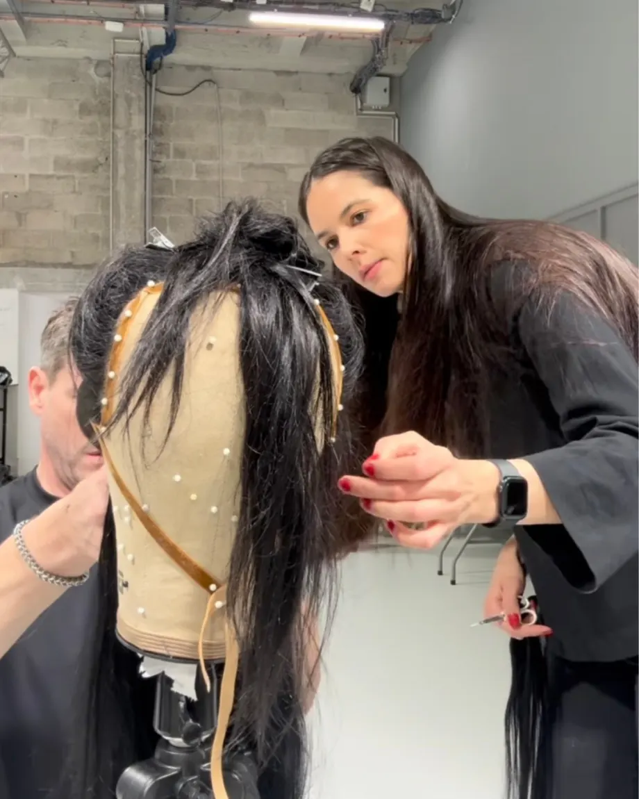Michelle Bowden works on a hair piece on a mannequin