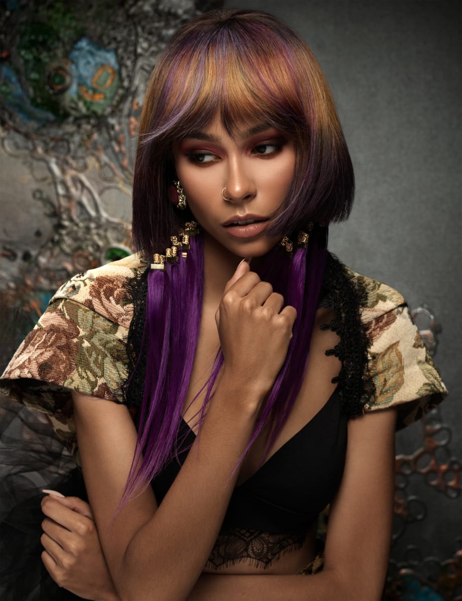 A woman with hair jewelry and multi-tonal haircolor.