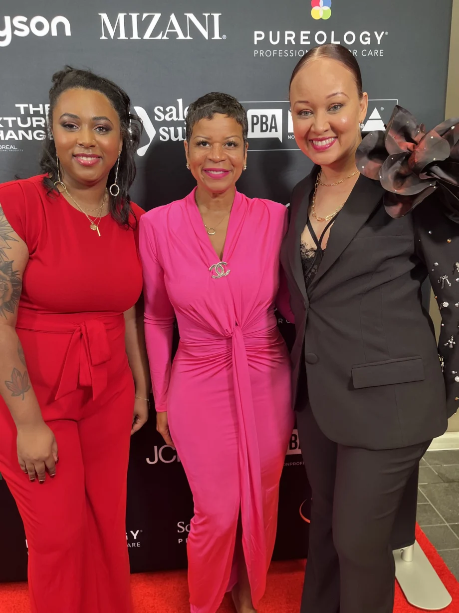 Nicole Johnson, Evie Johnson, and Jalia Pettis smile on the red carpet at the North American Hairstyling Awards.