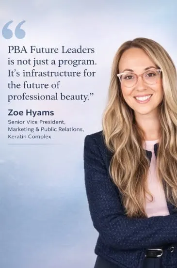 A woman with long blonde hair and glasses, smiling.