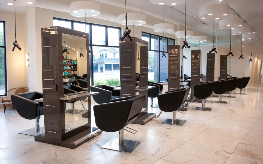 Back to Back salon stations in a sunny salon floor at Excuria.