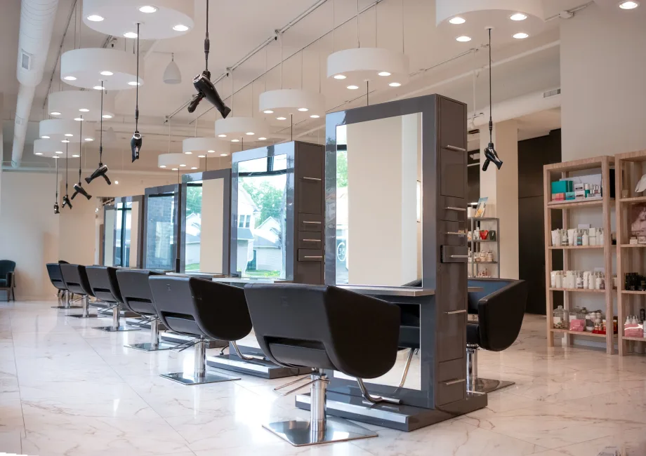 Back to Back salon stations in a sunny salon floor at Excuria.
