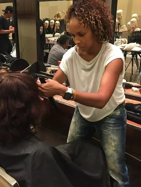 A hairdresser working in front of a client